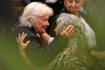 A woman comforts Uruguay's former